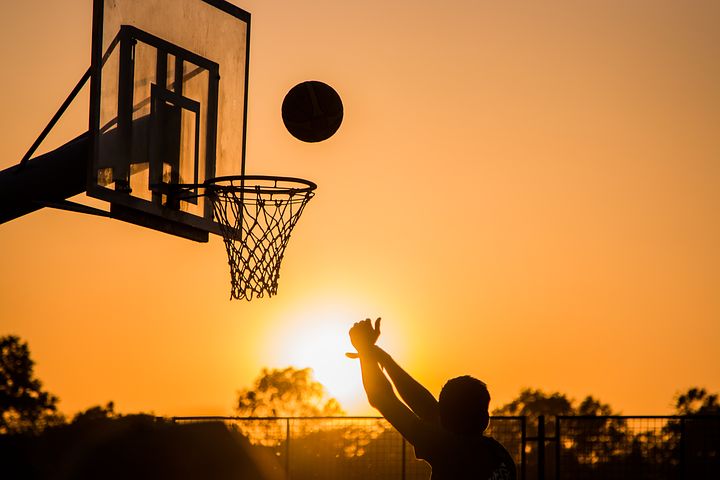 Shooting a basketball shot during sunset is a metaphor for great salary