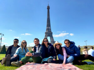MBA students and their partners in front of the Eiffel Tower